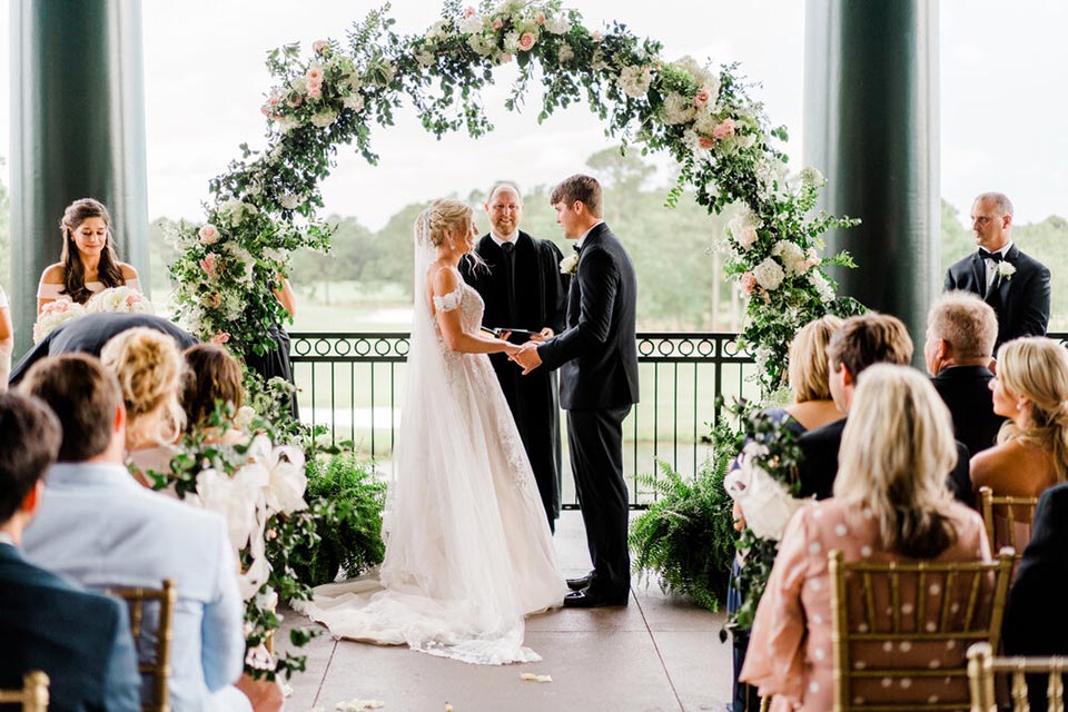 Photo of bride and groom on veranda getting married