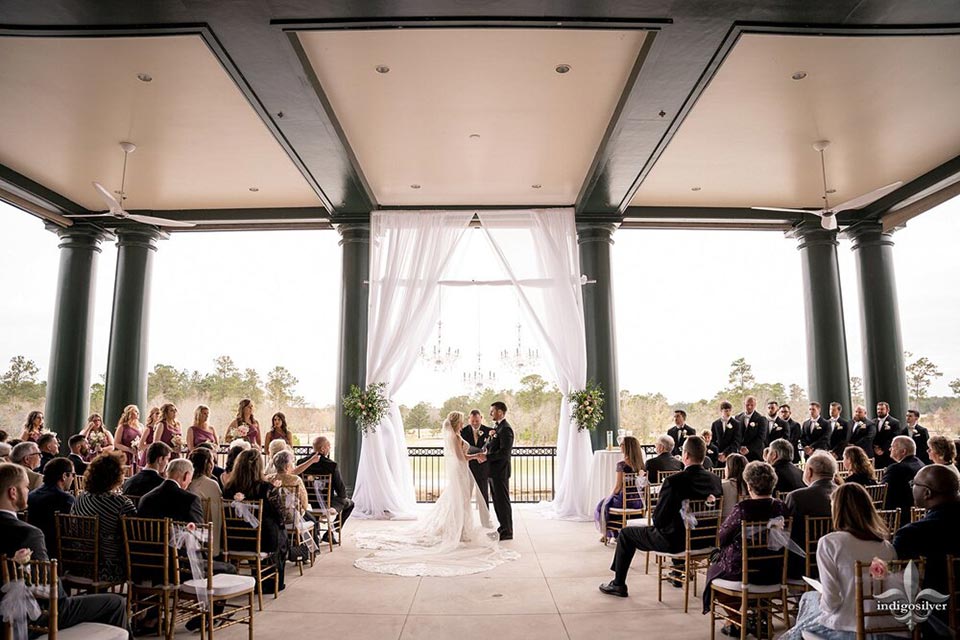 Photo of bride and groom on veranda getting married