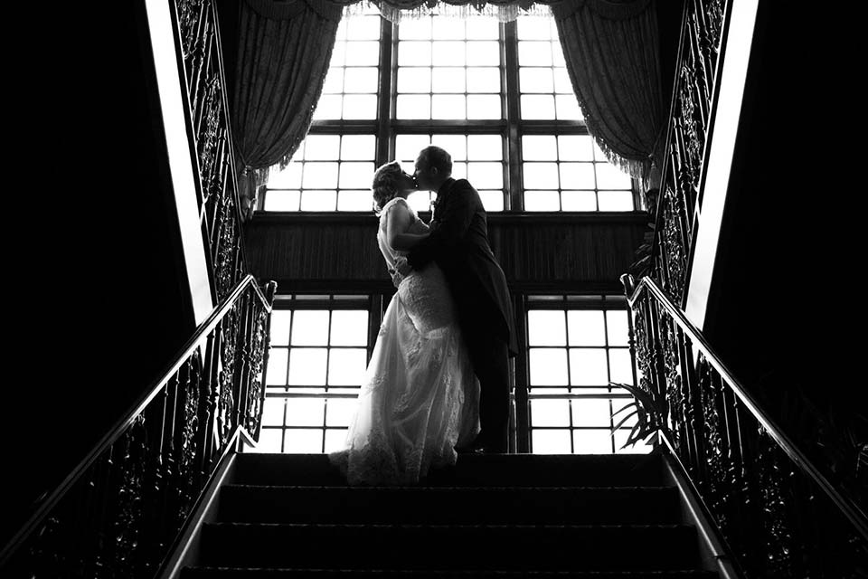 Photo of a bride and groom on staircase inside the Mad Boar