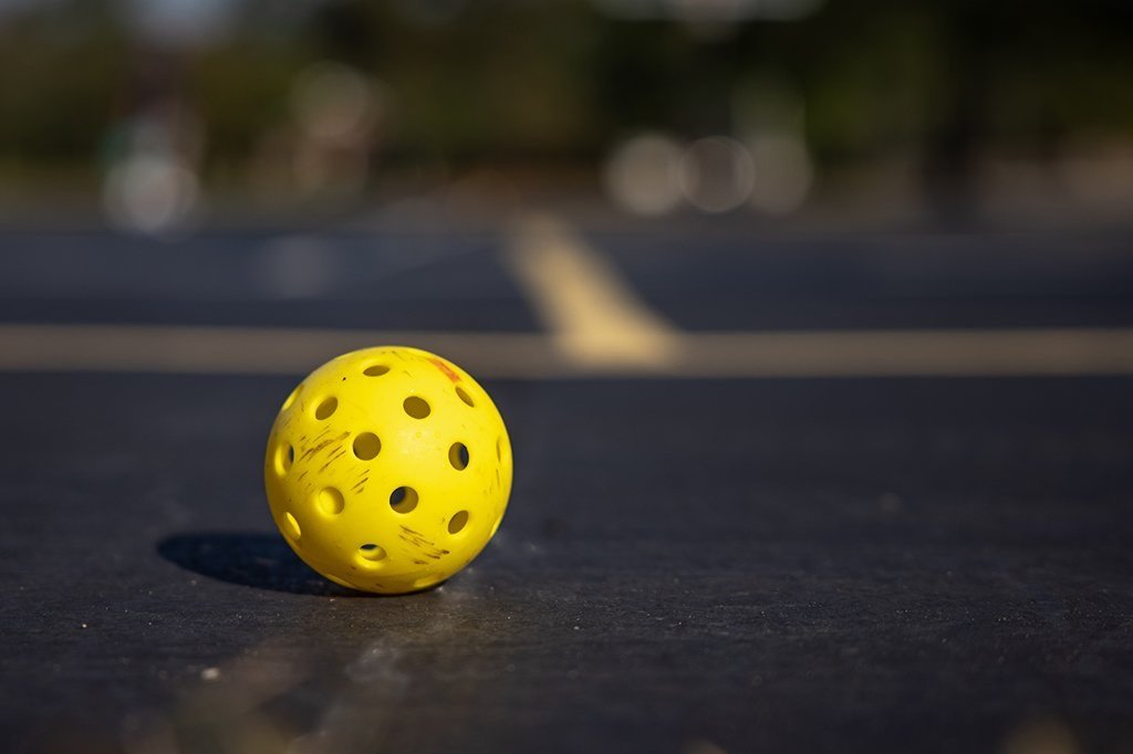 yellow tennis ball on tennis court
