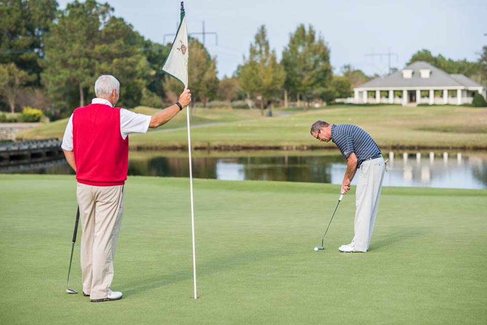 Photo of two men golfing at River Landing