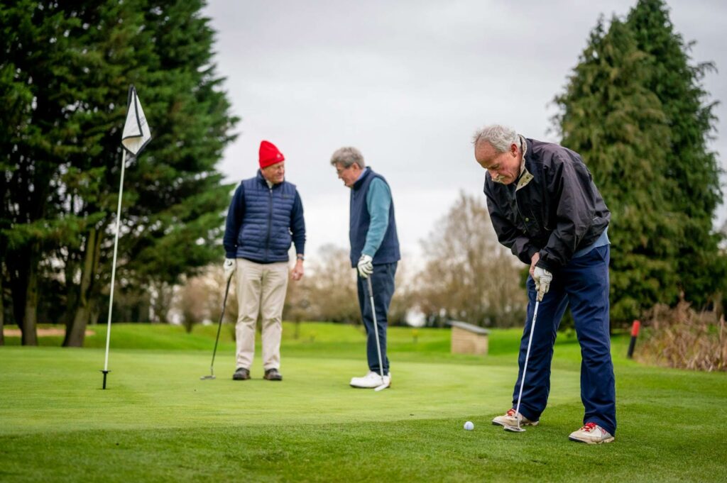 Photo of senior men playing golf