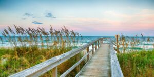 Photo of wooden walkway to beach at sunrise