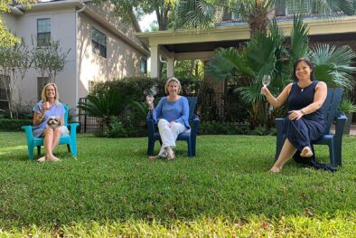 Photo of 3 women drinking wine on the lawn