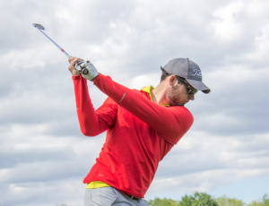man swinging golf club