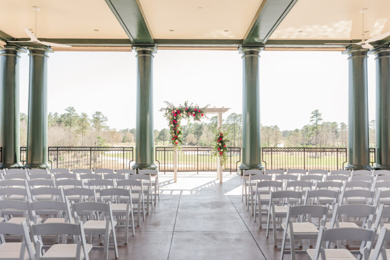 Terrace venue with several rows of chairs and roses