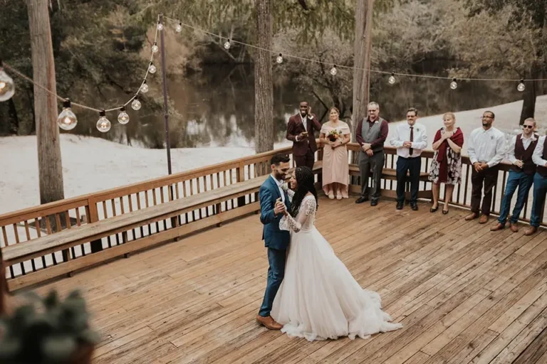 Photo of bride and groom dancing outside in the winter