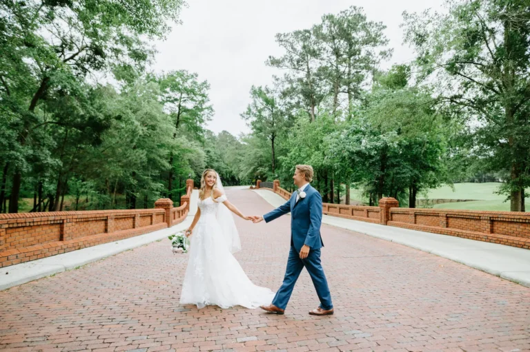 couple on bridge holding hands